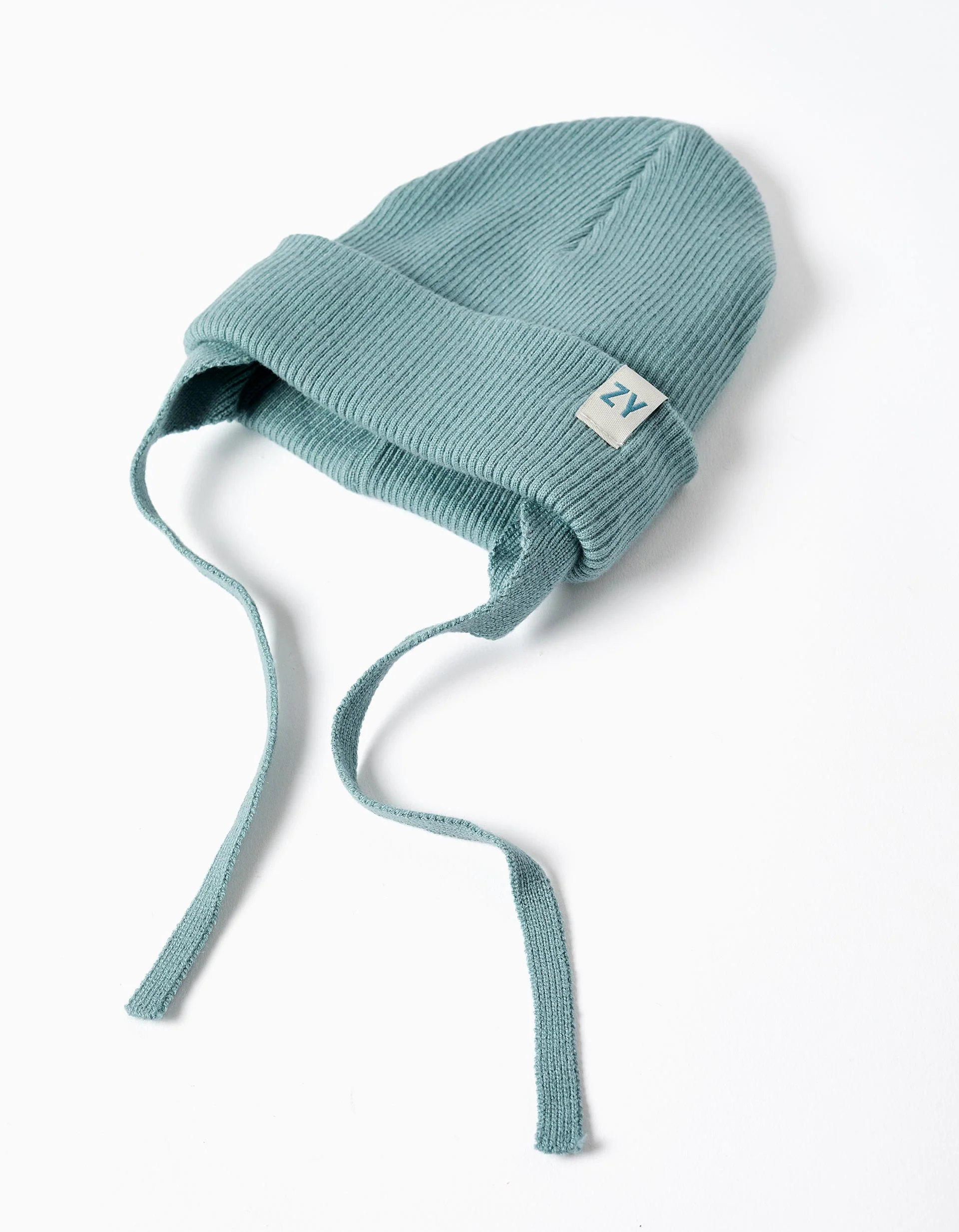 Knitted beanie with straps and ear protection for baby boys, blue green